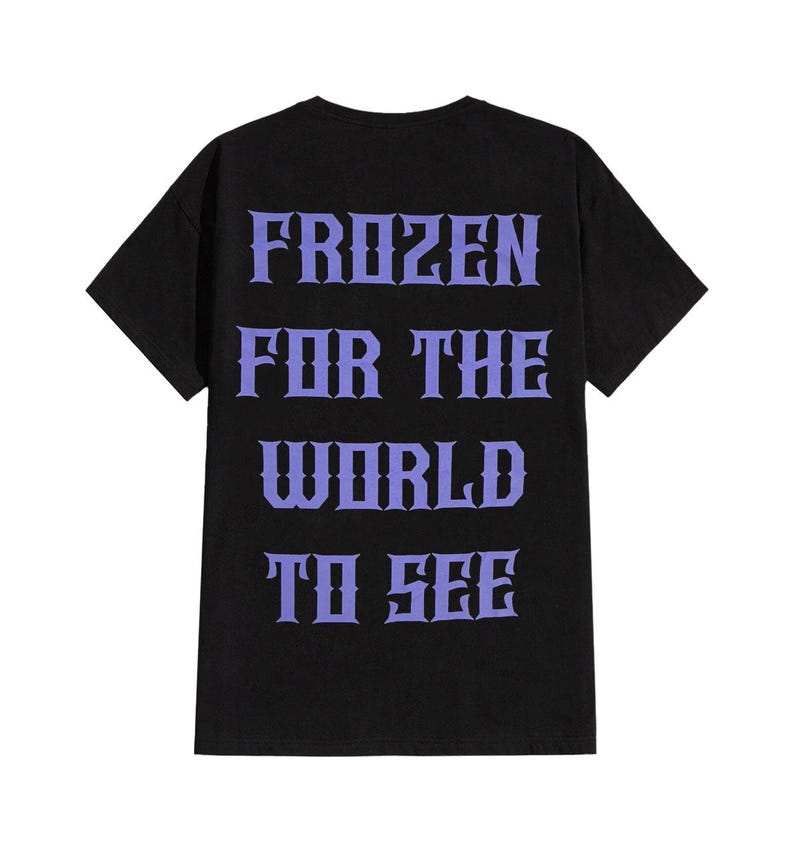 May include: Black t-shirt with the text "FROZEN FOR THE WORLD TO SEE" in a stylized purple font. The shirt has a crew neck and short sleeves. The text is centered on the back of the shirt.