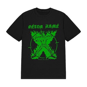 May include: A black short-sleeve t-shirt featuring a bright green graphic print. The design displays the text B&Eacute;TON ARM&Eacute; above a figure inside a circular target frame surrounded by flames, with the text Release the Shine at the bottom.