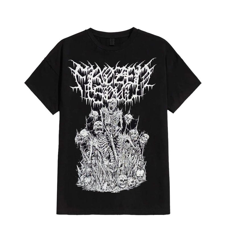 May include: Black t-shirt featuring a white graphic design. The design includes the text "Frozen Soul" in a stylized font above a detailed illustration of skeletons and skulls. The artwork is in a heavy metal style.