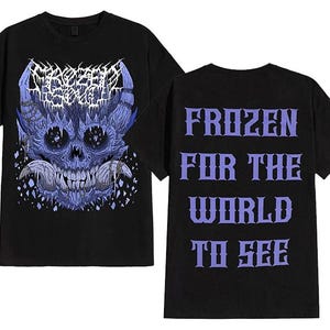 May include: Black t-shirt featuring a blue skull graphic with the text "Frozen Soul" on the front. The back of the shirt displays the text "Frozen for the World to See" in purple. A dark, edgy design.