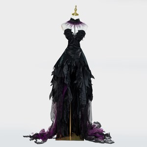 May include: A black formal gown with a high collar and a flowing skirt. The bodice is strapless and adorned with black fabric. The skirt features layers of black and purple fabric, creating a dramatic effect. The dress is displayed on a mannequin.