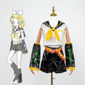 May include: A cosplay outfit featuring a white top with a black collar and yellow bow, paired with black shorts and arm sleeves. The outfit includes a red and yellow belt. A cartoon illustration of the character is on the left.