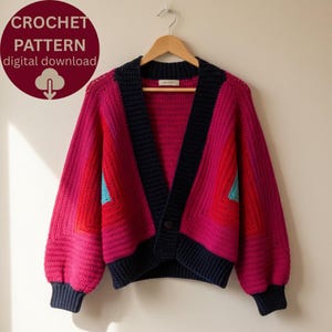 May include: A vibrant, color-blocked crochet cardigan in shades of pink, red, and navy blue, with a turquoise accent. The garment is displayed on a wooden hanger. The image includes a circular graphic with the text "CROCHET PATTERN digital download".