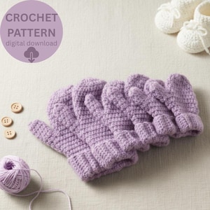 May include: A collection of crocheted lavender mittens, with a matching ball of yarn and wooden buttons. The image includes the text "CROCHET PATTERN digital download". White crocheted baby booties are in the background.