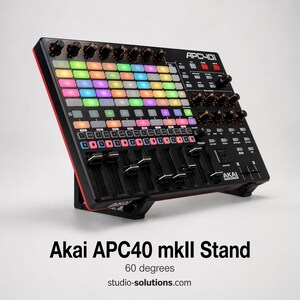 May include: Black Akai APC40 mkII stand with a red trim. The stand is angled at 60 degrees and features a grid of multi-colored illuminated pads, knobs, and faders. The text "APC40" and "AKAI" are visible on the device. The website studio-solutions.com is also visible.