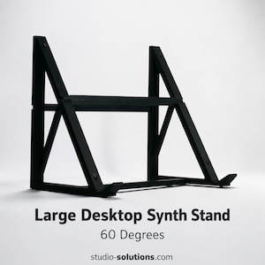 May include: A black wooden desktop synth stand with a 60-degree angle. The stand has a sturdy, geometric design with angled supports and a flat surface for a synthesizer. The text "Large Desktop Synth Stand" is visible.