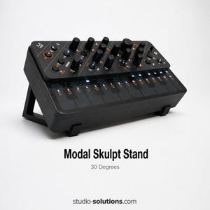 May include: Black Modal Skulpt Stand angled at 30 degrees. The stand has a keyboard layout with multiple knobs and buttons. The text "Modal Skulpt Stand" and "30 Degrees" are visible on the stand.