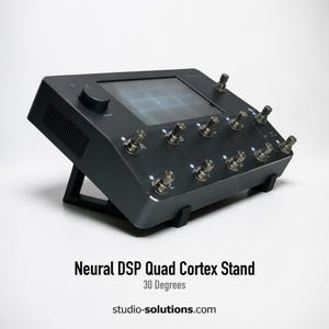 May include: A black Neural DSP Quad Cortex stand, angled at 30 degrees, featuring a screen and multiple input jacks. The stand is supported by a black frame. The text "Neural DSP Quad Cortex Stand" and "30 Degrees" are visible.