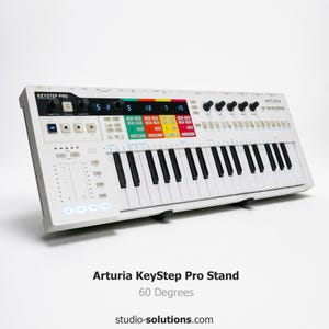 May include: A white Arturia KeyStep Pro synthesizer with black and white keys, colorful buttons, and knobs. The text "KEYSTEP PRO" and "ARTURIA" are visible on the device. The stand is at a 60-degree angle.