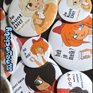 Könnte beinhalten: Eine Sammlung weißer runder Knöpfe mit Cartoon-Illustrationen und Text. Die Knöpfe zeigen Anime-Charaktere mit orangefarbenem und blondem Haar. Der Text enthält "Je Kunt Dit!", "heb je melk?" und "I have autism".