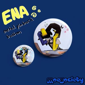 May include: Two metal pinback buttons with a cartoon illustration of a character holding a yellow drink. The buttons are white with the character in blue, yellow, and gray. The text "ENA" and "metal pinback button" are in yellow and black.