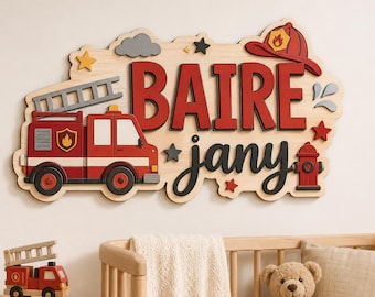 May include: A wooden wall sign featuring a red fire truck, a fire helmet, and a fire hydrant. The sign displays the name BAIRE in large red block letters and jany in black script. Decorative elements include a ladder, stars, and clouds.