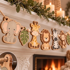 May include: A decorative garland featuring wooden cutouts of a gray elephant, a green leaf, a yellow giraffe, a brown lion, a black and white zebra, and a brown monkey strung on a rope. A small inset shows the wood thickness is 3mm.