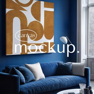 May include: A square canvas print featuring a white and mustard yellow abstract geometric pattern hangs on a deep blue wall above a blue sofa. The text "canvas mockup." is overlaid in white across the center of the image.