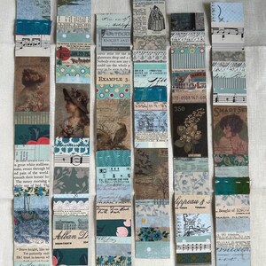 May include: A collection of handmade paper bookmarks with a vintage aesthetic. Each bookmark is a vertical rectangle composed of layered paper strips in shades of blue, green, and brown, with printed text and illustrations. Some include floral and musical notes.