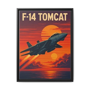 May include: Framed canvas art print featuring an F-14 Tomcat fighter jet soaring over a sunset. The artwork displays the text "F-14 TOMCAT" in a bold font, with a vibrant orange and red color palette.