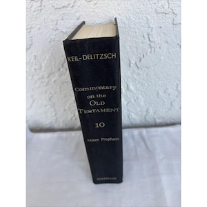 May include: A black hardcover book titled "KEIL-DELITZSCH Commentary on the Old Testament 10 Minor Prophets." The book has gold lettering and a textured cover. The pages are cream-coloured.