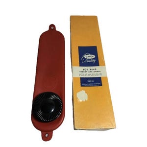 May include: A vintage red rubber ice bag with a black screw-on cap and a matching box. The box is yellow with blue text that reads "Davol Quality Ice Bag Throat and Spinal".