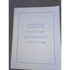 May include: A white paper program for the Chief Sealth High School Class of 1968 20-year reunion held on August 20, 1988. The cover features light blue text and a thin light blue rectangular border framing the printed information on the front.