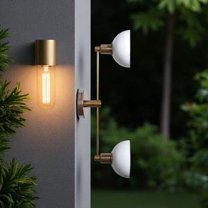 May include: Contemporary outdoor lighting fixtures. One features a gold-coloured cylindrical top with a long, exposed filament bulb. Another has two white, semi-circular shades and gold-coloured arms, mounted on a wall.