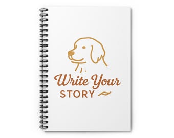 May include: A white spiral-bound notebook with the words "Write Your Story" in brown script, accompanied by a line drawing of a dog's head. The notebook's design is simple and elegant, perfect for journaling or note-taking.