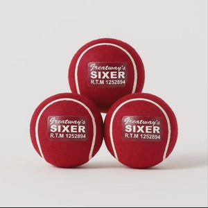 May include: Three red tennis balls with white seams and the text "Greatway's SIXER R.T.M 1252894" on each ball. The balls are arranged in a triangular formation against a plain background.