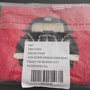May include: A red beaded pouch with a black and beige design. The pouch is in a clear plastic bag. The pouch has a beaded design of a vehicle. The pouch has a tag with text.