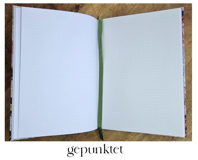 May include: Open dot grid journal with floral patterned covers and a green ribbon bookmark. The pages are blank with a dot grid pattern. The word "gepunktet" is printed at the bottom of the image.