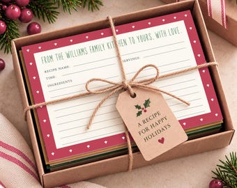 May include: A set of recipe cards in a brown cardboard box, tied with twine and a tag reading A RECIPE FOR HAPPY HOLIDAYS. The top card features a red border with white accents and the text FROM THE WILLIAMS FAMILY KITCHEN TO YOURS, WITH LOVE.
