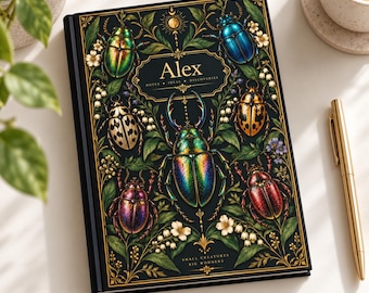May include: A black hardcover notebook featuring a gold-bordered central label with the name Alex, Notes, Ideas, Discoveries. The cover displays colorful iridescent beetles and white lily of the valley flowers with gold filigree accents.