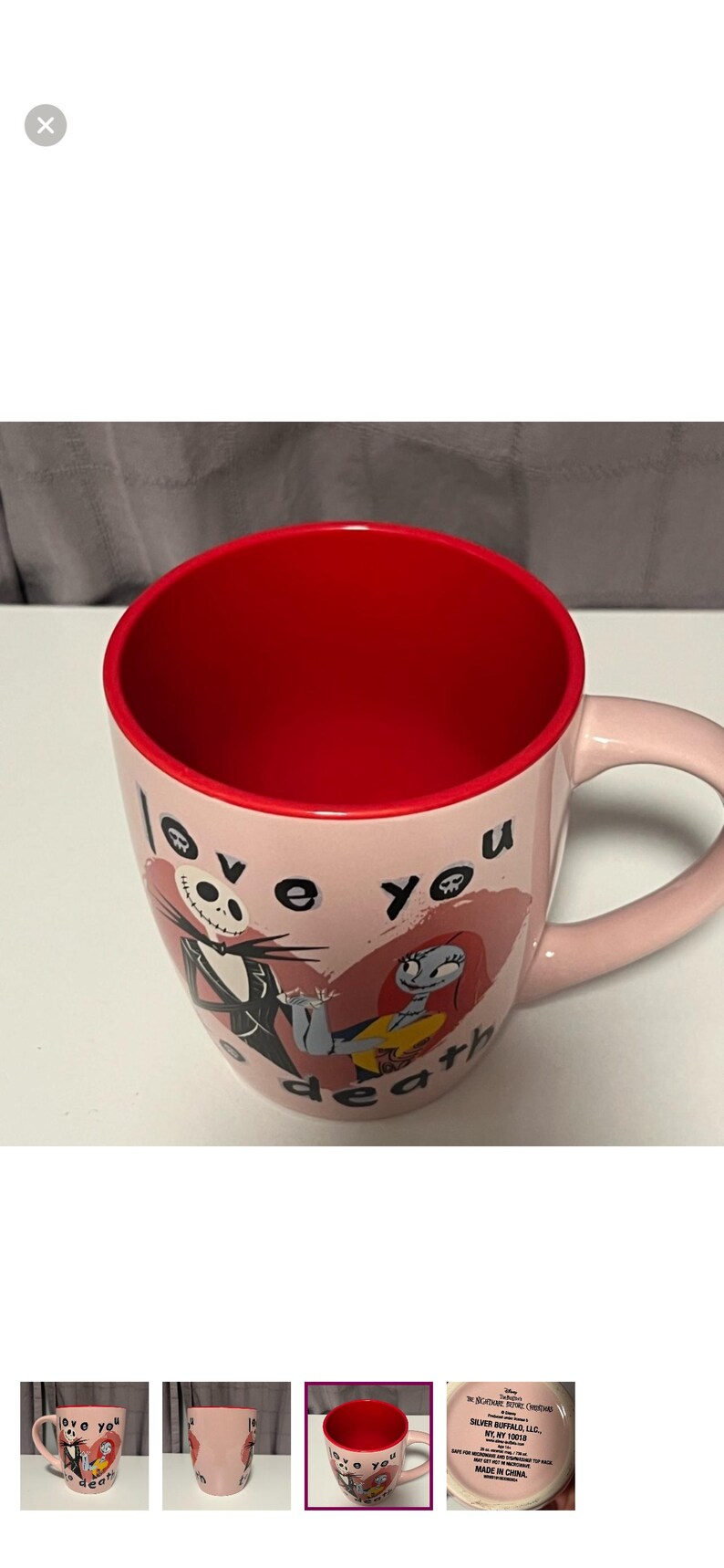May include: Pink ceramic mug with a red interior featuring Jack Skellington and Sally from The Nightmare Before Christmas. The mug has the words "love you death" printed on it.