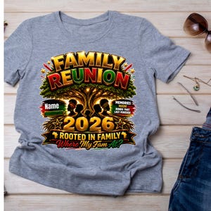 May include: A heather gray t-shirt featuring a graphic with the text FAMILY REUNION, 2026, ROOTED IN FAMILY, Where My Fam At?, and MEMORIES MADE BONDS THAT LAST FOREVER. The design includes a large tree, silhouettes of people, and stars.