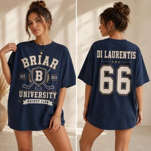 A woman wearing a navy blue t-shirt with the text "BRIAR UNIVERSITY HOCKEY CLUB" printed on it.