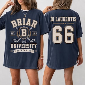 A woman wearing a navy blue t-shirt with the text "BRIAR UNIVERSITY HOCKEY CLUB" printed on it.