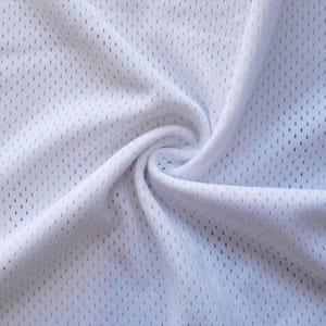 a close-up view of a white fabric with a perforated pattern, likely a type of athletic or sportswear material.
