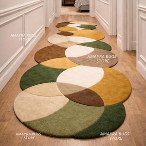 May include: A hallway runner composed of several circular rugs. The rugs are segmented into sections of beige, brown, green, and yellow. The text "AMAYRA RUGS STORE" is printed on some of the rugs. The rugs are arranged in a line.