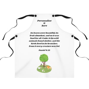 May include: White apron with black ties. The apron has the text "Personalize It here" and a colourful illustration of a tree, people, and animals, with the Bible verse Daniel 4:12.