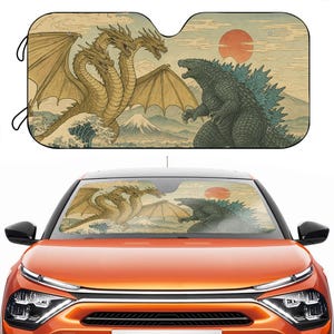 May include: Car sunshade featuring a Japanese-style illustration of Godzilla and King Ghidorah facing each other. The artwork includes a red sun, mountains, and ocean waves, with a beige and green color scheme.