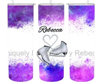 May include: A set of three stainless steel tumblers with a watercolor design of purple and pink hues. The center tumbler features the name "Rebecca" and a pair of ice skates with a heart design.