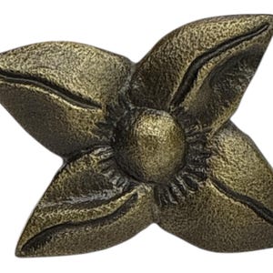 May include: A bronze-colored, four-petal flower-shaped decorative element. The petals have a textured surface and are arranged around a central, spherical detail. The overall design has a vintage or antique aesthetic.