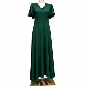 May include: A floor-length dark green dress featuring a V-neckline and short, flared flutter sleeves. The garment has a fitted bodice that transitions into a flowing, A-line skirt that extends to the floor, creating a simple and uniform silhouette.