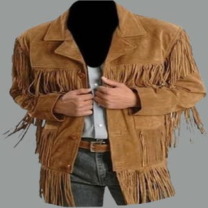 May include: A brown suede jacket with long fringe detailing on the sleeves, chest, and hem. The jacket has a classic collar, button closure, and two front pockets. The jacket is a medium brown colour and has a western style.