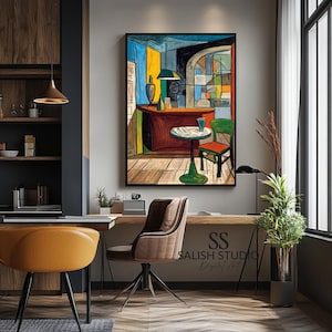 May include: An abstract painting in a black frame depicts a colorful interior scene with a bar, table, and chair. The artwork features bold lines and vibrant colors, including red, blue, yellow, and green. The painting hangs above a wooden desk with a brown chair.