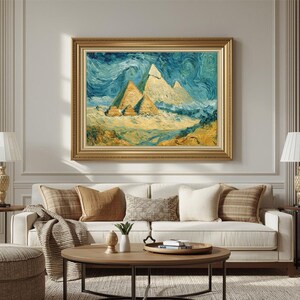 May include: A framed painting depicts the pyramids of Giza under a swirling blue and white sky. The artwork, in a gold frame, features a textured, impressionistic style with yellow, beige, and blue hues. The painting is displayed above a white sofa.