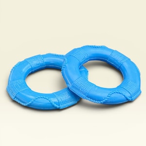 May include: Two bright blue plastic life preserver rings featuring a molded rope texture around the circumference and raised rectangular segments. These circular nautical-themed items have a smooth, glossy finish and a hollow center design.