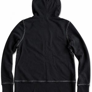 May include: A black hoodie with a hood and long sleeves. The hoodie has white stitching along the seams and cuffs. The back of the hoodie is visible, and the fabric appears to be a soft material.