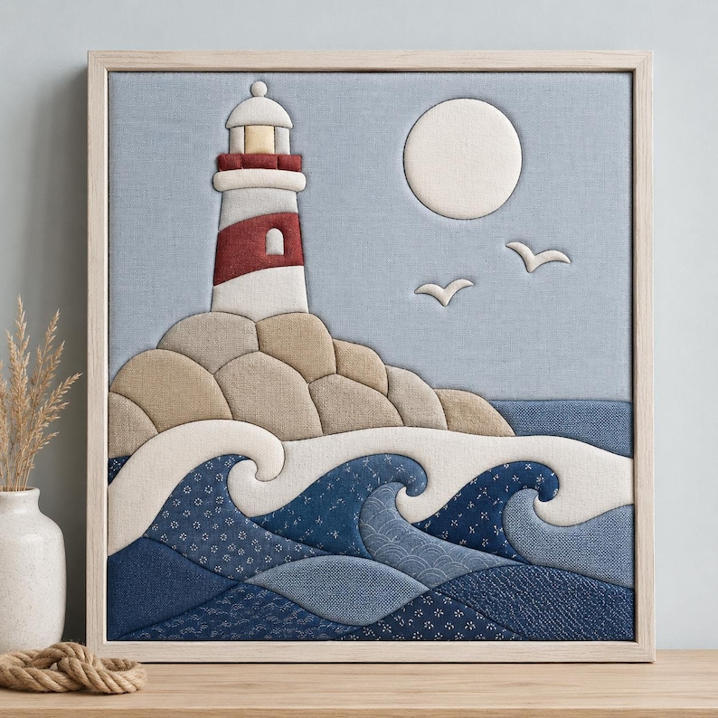 May include: A square fabric wall art piece featuring a layered textile lighthouse in white and red, set against a light blue background. The scene includes a white moon, two white birds, beige rocky cliffs, and stylized dark blue ocean waves.