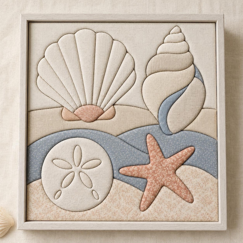 May include: A square framed fabric wall art piece featuring a padded, quilted design of a large fan shell, a spiral conch shell, a sand dollar, and a starfish. The composition uses a palette of beige, soft blue, and muted coral fabric textures.
