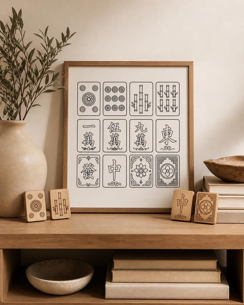 May include: A framed print of Mahjong tiles with black line art on a cream background. Wooden Mahjong tiles are displayed on a wooden shelf. A vase with greenery and a decorative bowl are also visible.