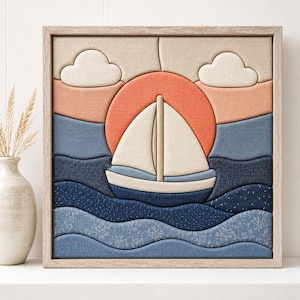 May include: A square fabric wall art piece featuring a layered textile design of a sailboat on wavy blue water against a large orange sun and two white clouds. The artwork is encased in a light-colored wooden frame with a textured fabric finish.
